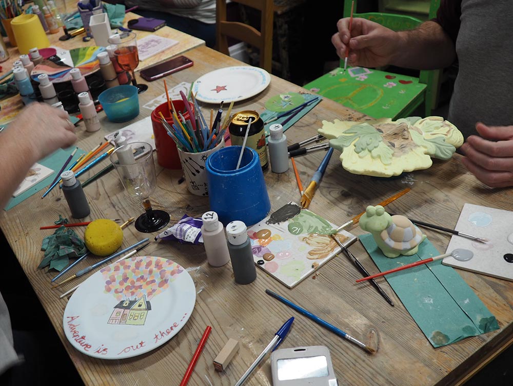 Painting pottery at Glazey Days